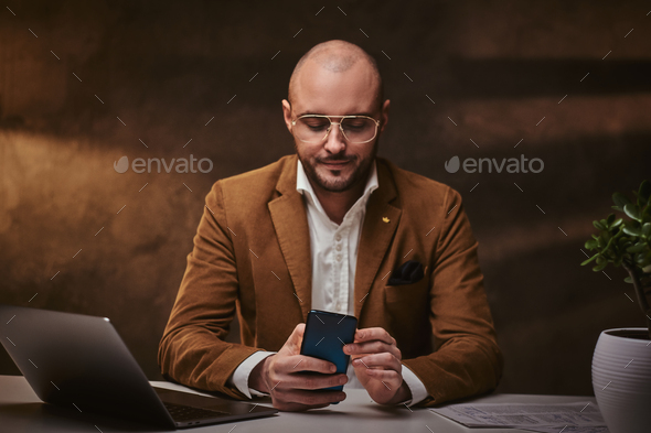 Confident european handsome businessman sitting in the office - Stock Photo - Images
