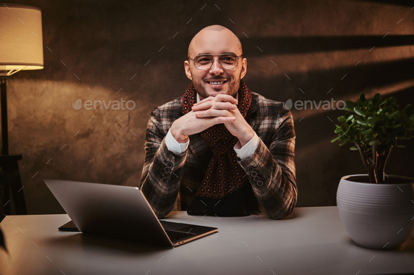 Confident european handsome businessman sitting in the office - Stock Photo - Images