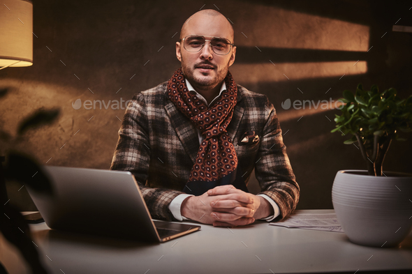 Confident european handsome businessman sitting in the office - Stock Photo - Images
