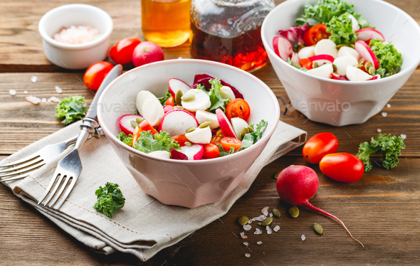 Salad with cherry tomatoes, radsh and mozzarella, lettuce mix - Stock Photo - Images