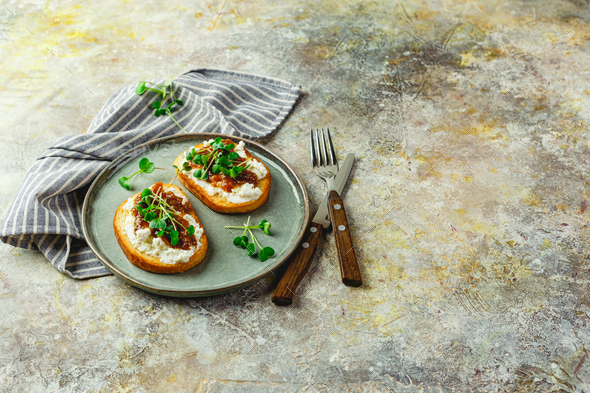 Canape or crostini with toasted baguette, cottage cheese, fig jam - Stock Photo - Images