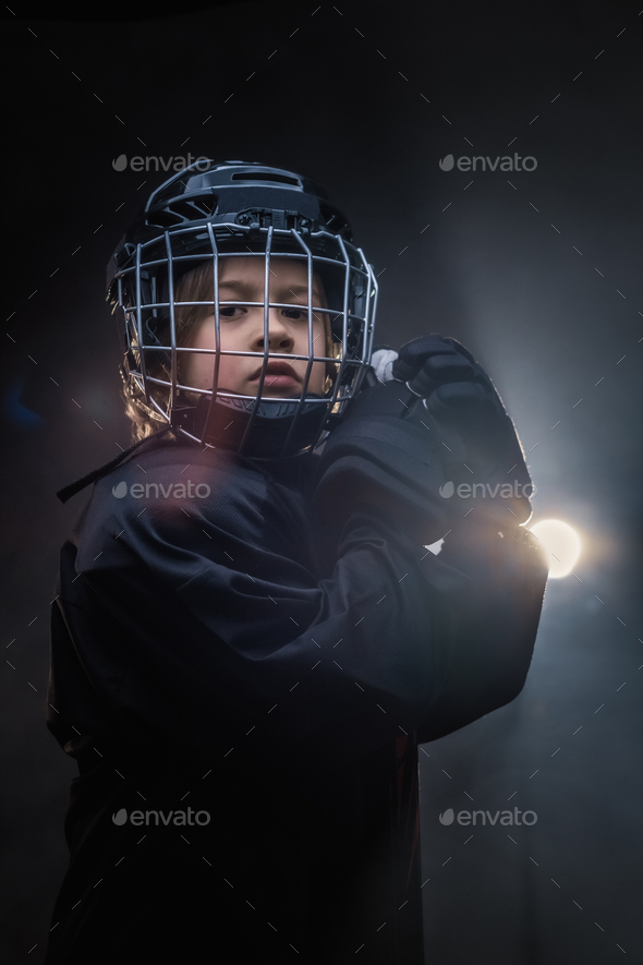Young hockey player posing in uniform for a photoshoot in a studio - Stock Photo - Images