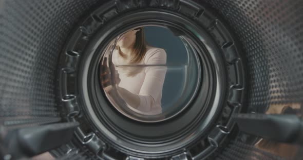 Woman smelling a bad odour in the washing machine