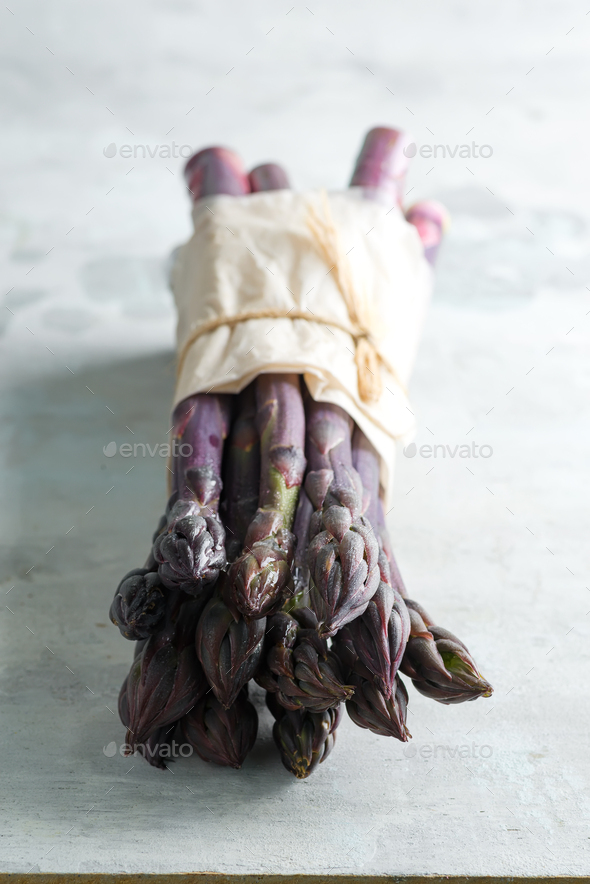 Home grown fresh natural organic purple asparagus bunch against stone background - Stock Photo - Images