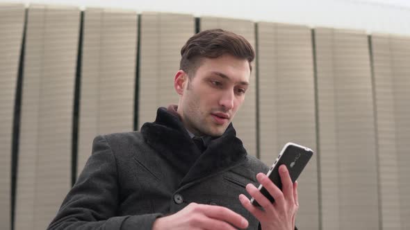 Young businessman receiving a call alt