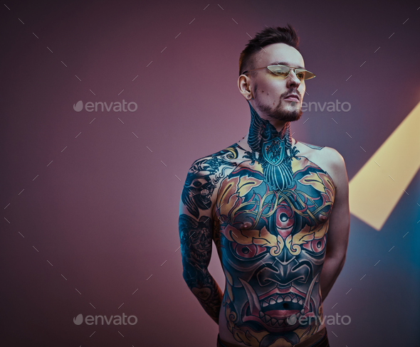Naked and inked Inked Male Model Posing In A Neon Studio With Half Naked Tattooed Body And Sunglasses Stock Photo By Fxquadro