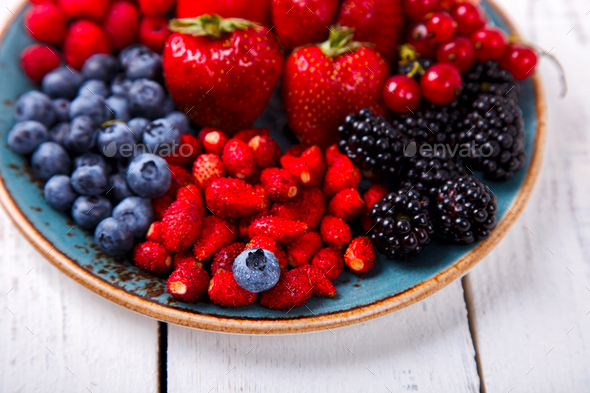 Various Fresh Summer Berries on a white Background.F - Stock Photo - Images