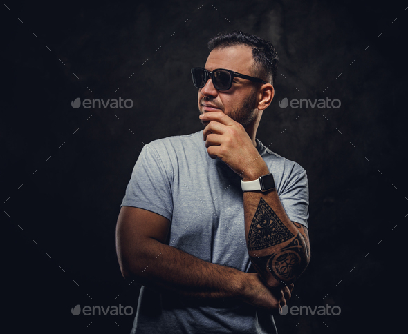Adult handsome man in a grey shirt and sunglasses - Stock Photo - Images