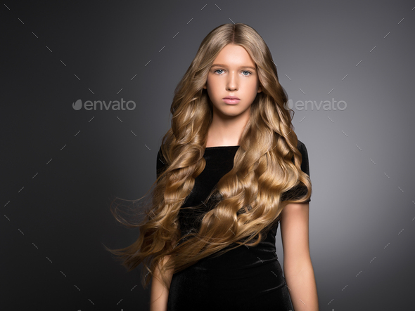 Long hair beauty girl healthy curly long hairstyle blonde in black dress  Stock Photo by kiraliffe