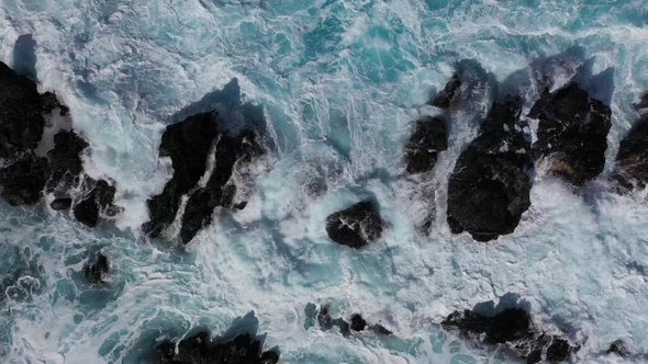 Waves of the Atlantic Ocean crash on coastal rocks alt