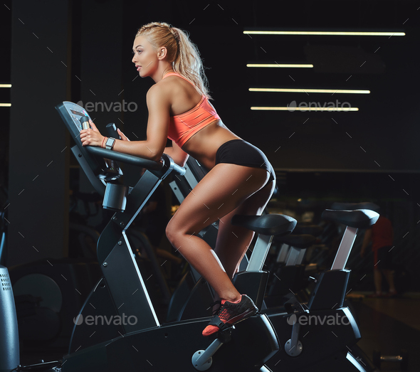 Sporty Beautiful Blond Woman In Sportswear Working Out Indoors