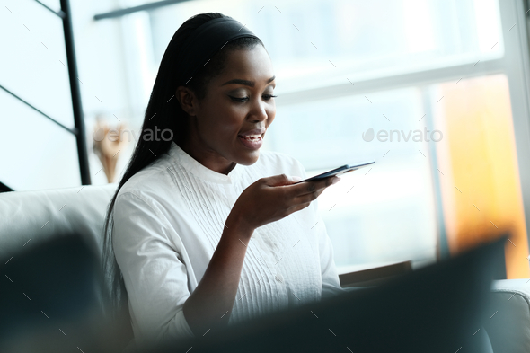 Black Woman Using Mobile Phone For Voice Mail