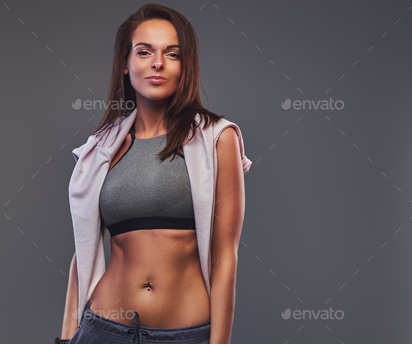 Brunette slim model in jeans and sports bra. Stock Photo by