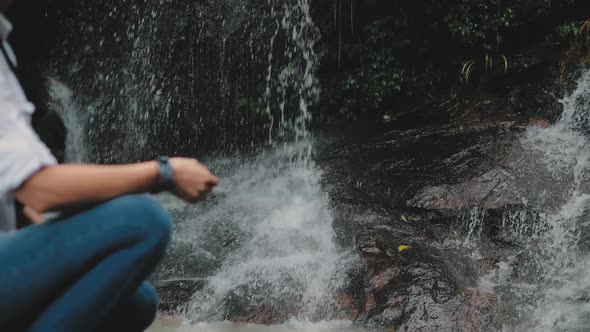 Girl Hiker Crouch Near Tropical Forest Waterfall