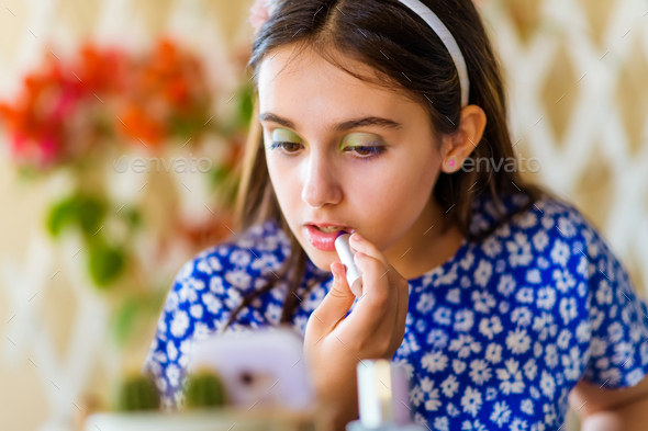 Young girl following an online makeup course