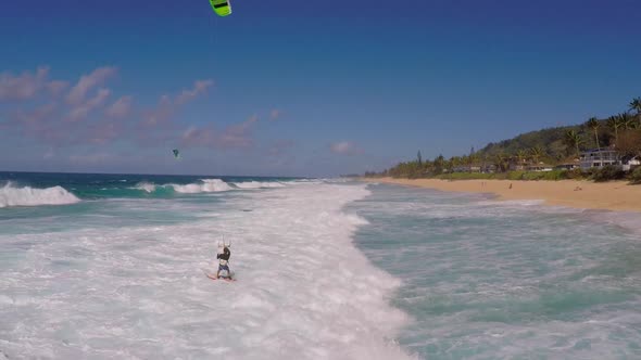 Aerial view of a man kitesurfing in Hawaii. alt