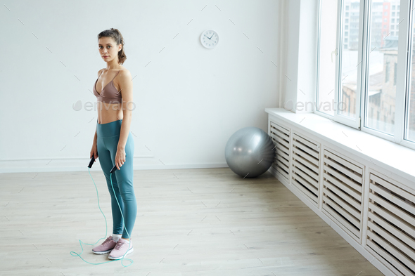 Young Woman Working Out with Skipping Rope