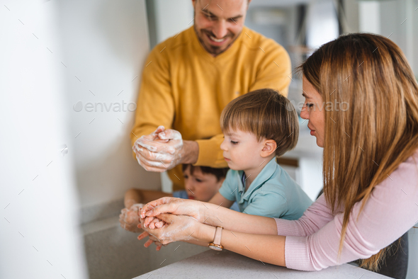 Beautiful young family are washing their hand. Protection against infection and virus