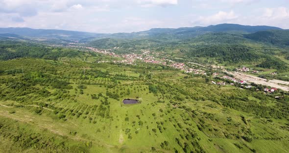 Flying over the rolling hills in Romania toward some cows. alt