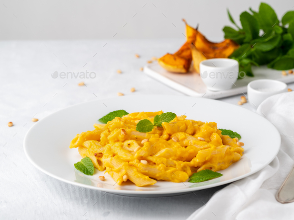 Pumpkin pasta penne with thick creamy sauce of baked squash and parmesan, side view