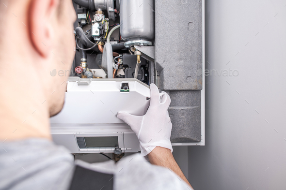 Contractor Repairing Central Heating Furnace System. - Stock Photo - Images