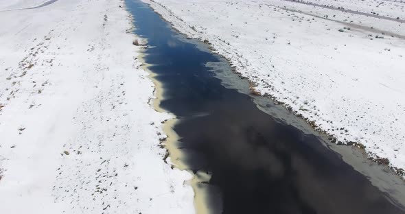 Aerial view of marshland covered with snow in The Netherlands. alt