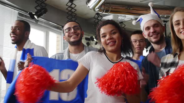 Group of mixed ethnic fans looking to camera