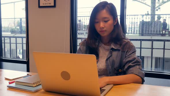 Businesswoman using laptop at office.