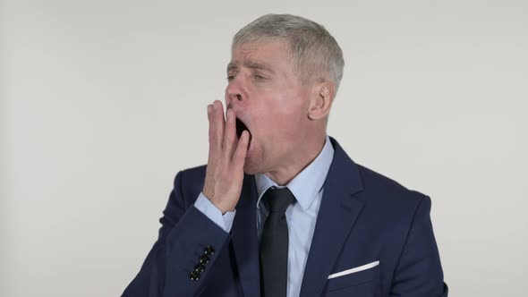 Senior Businessman Yawning and Stretching Body on White Background alt