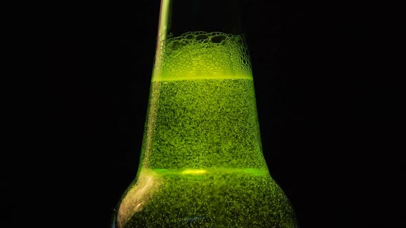 A Green Bottle neck with a lot of bubbles is on black background
