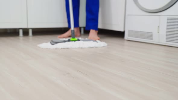 Close up of cleaning service woman worker cleaning in kitchen at home. alt