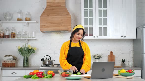 Woman Slices Cucumber Listen Teacher Chef Study Online Video Call Webcam Laptop alt