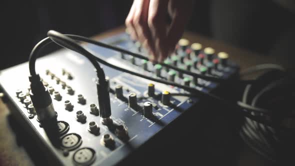 Mixer desk with many buttons and cables