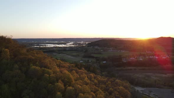 Gorgeous aerial view at sunset toward the Mississippi River with autumn colors seen in the forest.