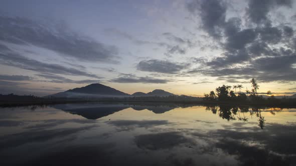 Timelapse sunrise in reflection of Bukit Mertajam Hill alt