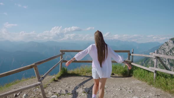 Girl Walks From Behind on the Italian Alps Mountains alt