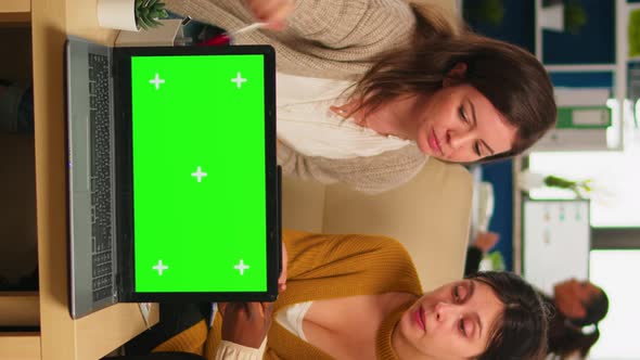 International Business Team Talking in Back of Mockup Laptop alt