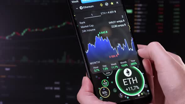 Broker touches screen with a finger, analyzes financial indicators ETH. alt