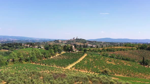 Tuscan Countryside Shot with Drone at Summer Time of Wine Fields Small Village in the Background alt