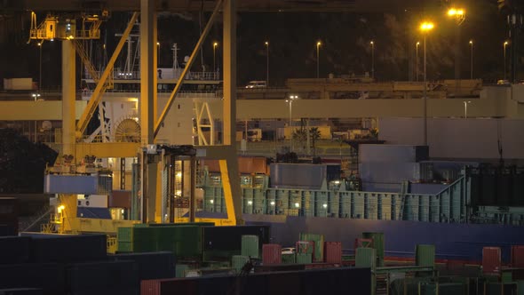 A Night View of a Cargo Ship Loading at Barcelona Port alt