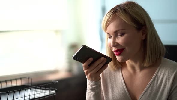 Woman Is Recording Voice Message at Smartphone and Sending, Modern Technology alt