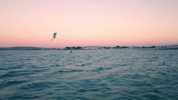 ultra wide drone shot following kite surfers on scenic sunset on Langebaan Beach, Cape Town, South a alt