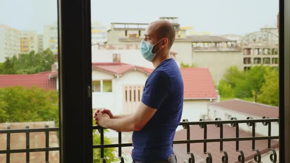 Man During Self Isolation Sitting on the Balcony alt