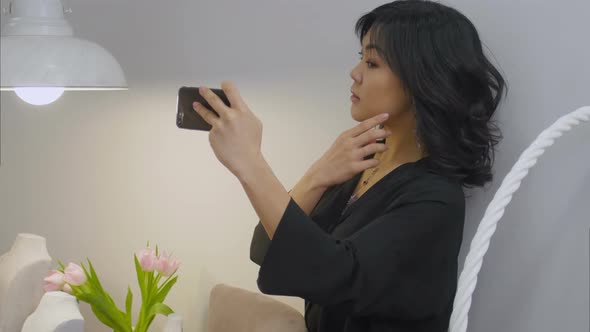 Asian Brunette Taking Selfie with Cellphone Wearing New Jewellery alt