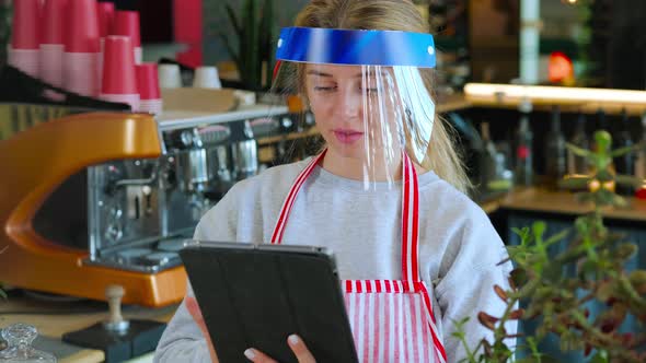 Barista Using Digital Tablet at Work alt