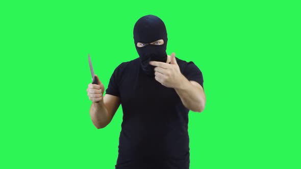 A man in a black mask holds a knife in his hand, showing that the enemy will feel 