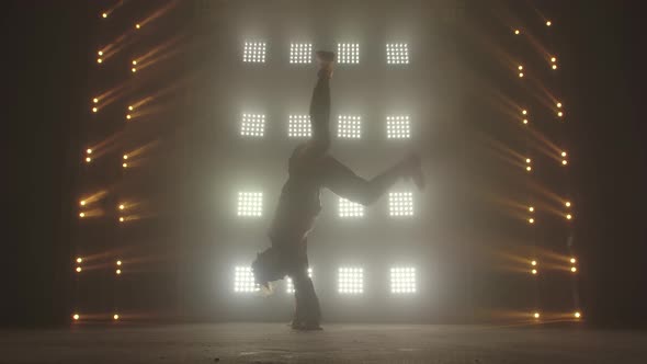 Breakdance Concept. Trendy Young Man Dancing Single in Club, Neon Light, Lots of Smoke. Fashion alt