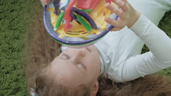 Little Girl Play with Threedimensional Toy Puzzle