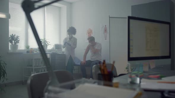 Woman Physician Vaccinating Man in Hospital alt