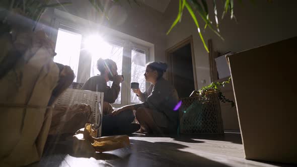 Man and Wife Drink Hot Beverages From Cups in New Flat